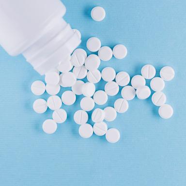 White bupropion pills spilled from a plastic bottle on a blue background. Bupropion is an effective antidepressant and smoking cessation aid, but overdose can be dangerous. Toxicity occurs at doses above 600 mg in adults and 10 mg/kg in children, with seizures as a major risk. Severe overdose may cause life-threatening complications like cardiac arrhythmias and respiratory failure